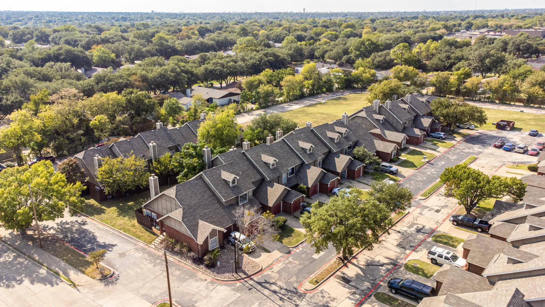 Aerial view of Wyngate Townhomes surrounded by mature trees in Garland