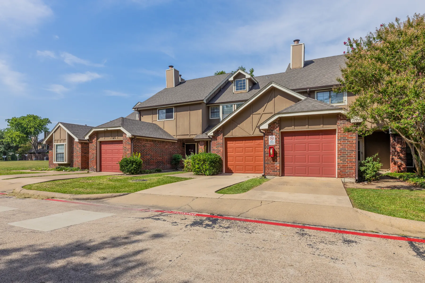 Brick townhomes with private garages and landscaping